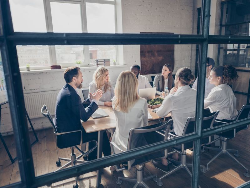 Sales team meeting around a conference table